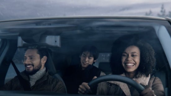 Three passengers riding in a vehicle and smiling | Grand Blanc Nissan in Grand Blanc MI
